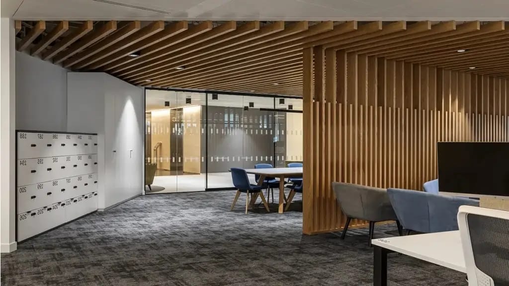 Modern office reception and co-working space in Noida — wood slat partitions and contemporary lounge seating by Decorette