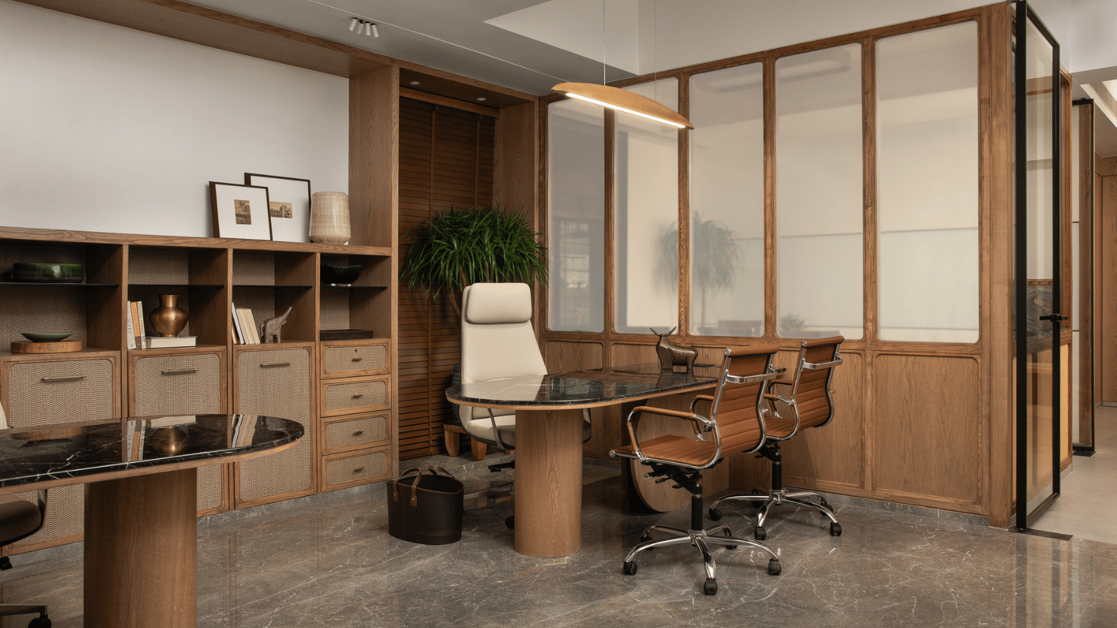 Executive office interior by Decorette — walnut panels, marble desk and leather seating in Cyber City
